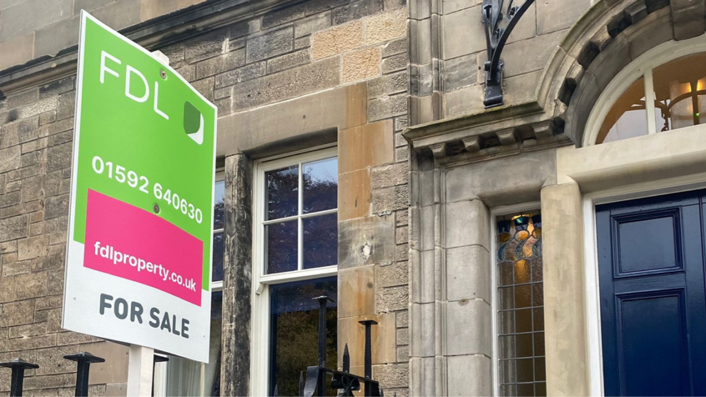 An FDL-branded sales board outside a property